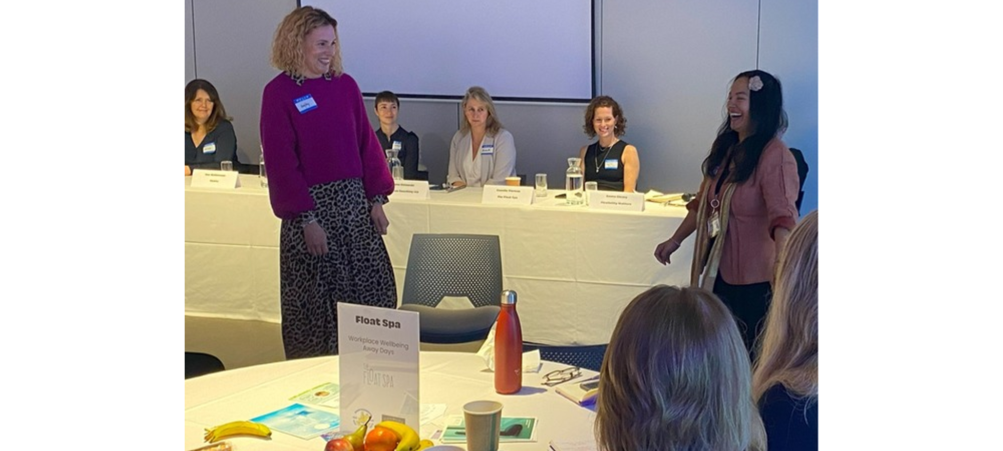 Sam Rehan leading a workplace wellbeing discussion with a team